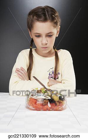 Girl refusing fruit salad View Large Photo Image Stock Photo - Girl refusing fruit salad. Fotosearch