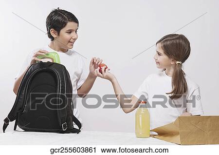 Girl sharing lunch with her friend View Large Photo Image Stock Image - Girl sharing lunch with her friend. Fotosearch