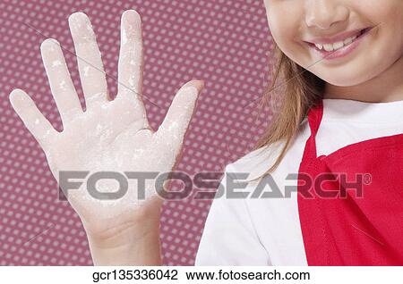 Girl showing her hand covered with flour View Large Photo Image Stock Image - Girl showing her hand covered with flour. Fotosearch