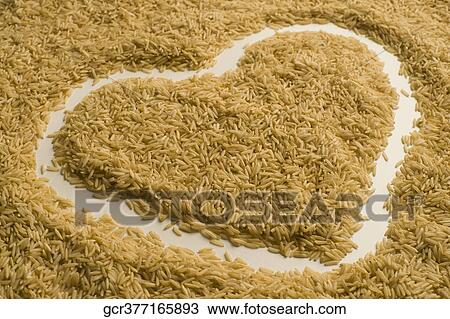 Heart shape drawn on brown rice View Large Photo Image Stock Image - Heart shape drawn on brown rice. Fotosearch