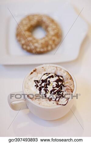 Stock Image - High angle view of a bagel with a cup of coffee. Fotosearch