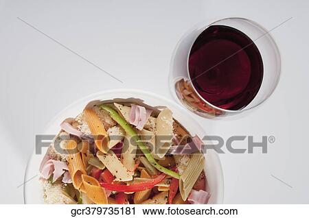 High angle view of a bowl of penne pasta with a wine glass View Large Photo Image Stock Image - High angle view of a bowl of penne pasta with a wine glass. Fotosearch