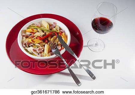 High angle view of a bowl of penne pasta and ham salad with glass of wine View Large Photo Image Stock Photograph - High angle view of a bowl of penne pasta and ham salad with glass of wine. Fotosearch