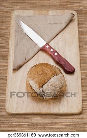 High angle view of a bun with napkin and a knife View Large Photo Image Stock Photo - High angle view of a bun with napkin and a knife. Fotosearch