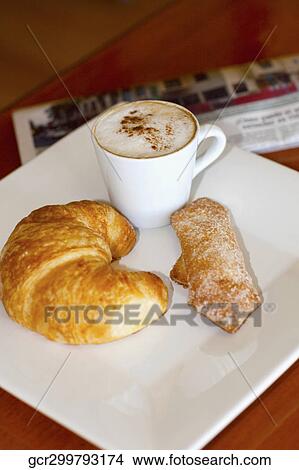 Picture - High angle view of a croissant and sugar cracker with a cup of coffee. Fotosearch