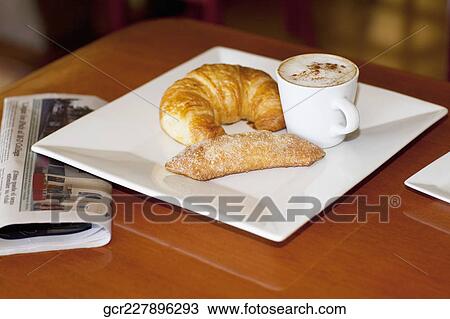 High angle view of a croissant and sugar cracker with a cup of coffee View Large Photo Image Stock Image - High angle view of a croissant and sugar cracker with a cup of coffee. Fotosearch