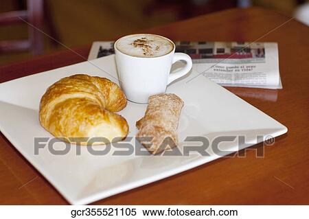High angle view of a croissant and sugar cracker with a cup of coffee View Large Photo Image Stock Photography - High angle view of a croissant and sugar cracker with a cup of coffee. Fotosearch