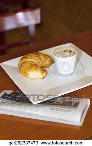 High angle view of a croissant with a cup of coffee View Large Photo Image Stock Image - High angle view of a croissant with a cup of coffee. Fotosearch