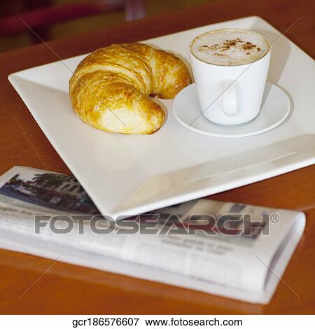 High angle view of a croissant with a cup of coffee View Large Photo Image Stock Photo - High angle view of a croissant with a cup of coffee. Fotosearch