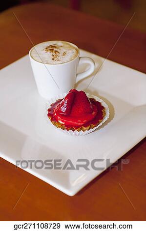 High angle view of a cup of coffee with a strawberry tart View Large Photo Image Stock Photo - High angle view of a cup of coffee with a strawberry tart. Fotosearch