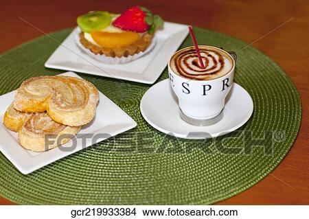 High angle view of a fruit tart and French hearts with a cup of coffee View Large Photo Image Picture - High angle view of a fruit tart and French hearts with a cup of coffee. Fotosearch