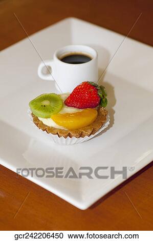 High angle view of a fruit tart with a cup of black coffee View Large Photo Image Stock Image - High angle view of a fruit tart with a cup of black coffee. Fotosearch