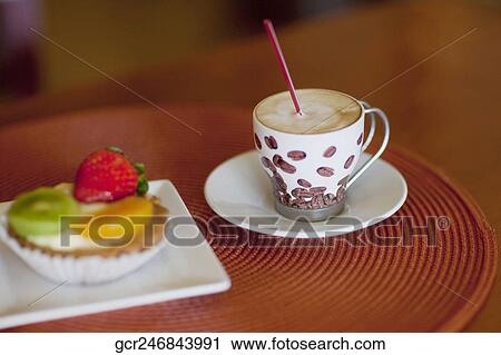 High angle view of a fruit tart with a cup of coffee View Large Photo Image Stock Image - High angle view of a fruit tart with a cup of coffee. Fotosearch