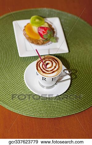 High angle view of a fruit tart with a cup of coffee View Large Photo Image Stock Photo - High angle view of a fruit tart with a cup of coffee. Fotosearch