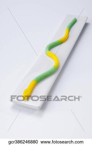Stock Image - High angle view of a marzipan snake on a platter. Fotosearch
