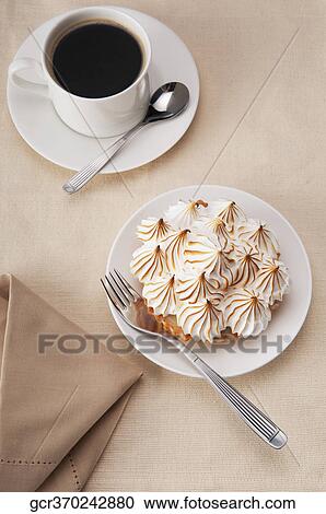High angle view of a meringue pie with a cup of black coffee View Large Photo Image Stock Image - High angle view of a meringue pie with a cup of black coffee. Fotosearch