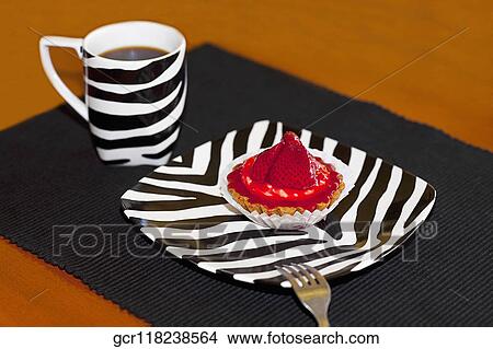 Picture - High angle view of a strawberry tart with a cup of coffee. Fotosearch