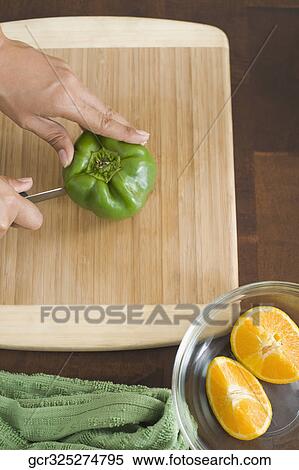 High angle view of a woman cutting a green bell pepper View Large Photo Image Stock Photography - High angle view of a woman cutting a green bell pepper. Fotosearch