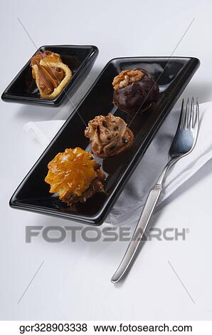 High angle view of assorted chocolate tarts View Large Photo Image Stock Photo - High angle view of assorted chocolate tarts. Fotosearch