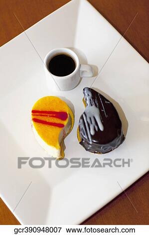 High angle view of assorted pastries and a cup of black coffee View Large Photo Image Stock Photo - High angle view of assorted pastries and a cup of black coffee. Fotosearch