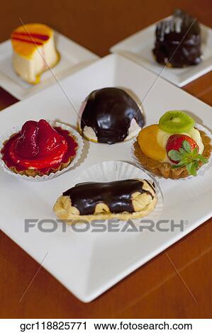 High angle view of assorted tarts and eclairs View Large Photo Image Stock Image - High angle view of assorted tarts and eclairs. Fotosearch