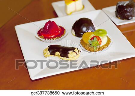 High angle view of assorted tarts and eclairs View Large Photo Image Stock Image - High angle view of assorted tarts and eclairs. Fotosearch