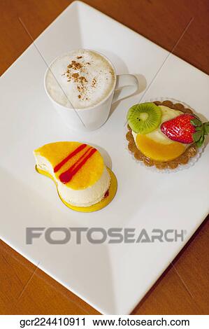 High angle view of assorted tarts with a cup of coffee View Large Photo Image Stock Image - High angle view of assorted tarts with a cup of coffee. Fotosearch