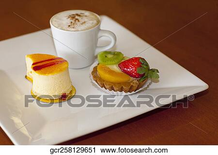 High angle view of assorted tarts with a cup of coffee View Large Photo Image Stock Image - High angle view of assorted tarts with a cup of coffee. Fotosearch