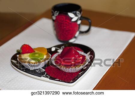 High angle view of assorted tarts with a cup of coffee View Large Photo Image Stock Image - High angle view of assorted tarts with a cup of coffee. Fotosearch