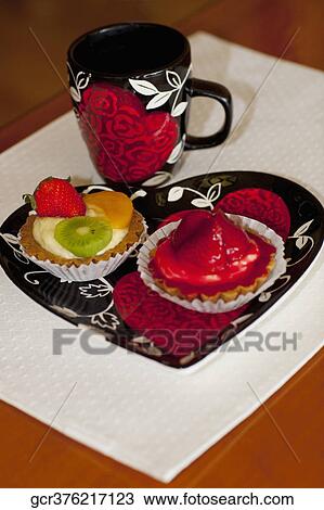 High angle view of assorted tarts with a cup of coffee View Large Photo Image Stock Image - High angle view of assorted tarts with a cup of coffee. Fotosearch