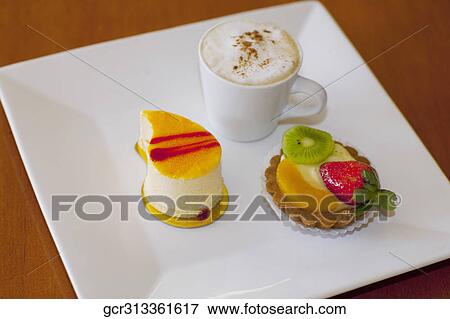 High angle view of assorted tarts with a cup of coffee View Large Photo Image Stock Photo - High angle view of assorted tarts with a cup of coffee. Fotosearch