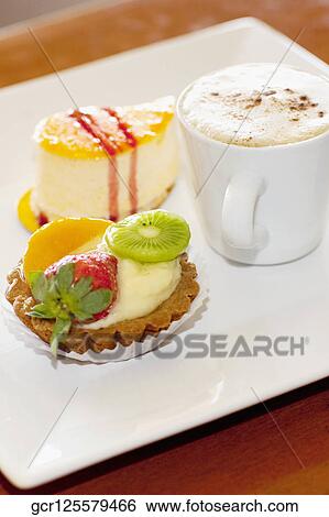 High angle view of assorted tarts with a cup of coffee View Large Photo Image Stock Photograph - High angle view of assorted tarts with a cup of coffee. Fotosearch