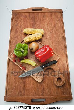 High angle view of assorted vegetables on a cutting board View Large Photo Image Stock Photo - High angle view of assorted vegetables on a cutting board. Fotosearch