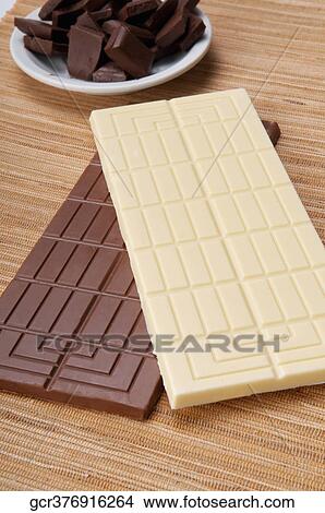 High angle view of bars of white and brown chocolate View Large Photo Image Picture - High angle view of bars of white and brown chocolate. Fotosearch