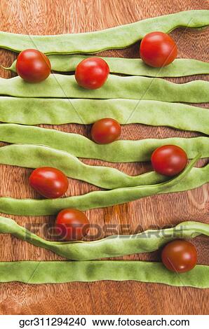 High angle view of beans with cherry tomatoes on a cutting board View Large Photo Image Stock Image - High angle view of beans with cherry tomatoes on a cutting board. Fotosearch