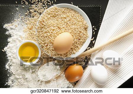 High angle view of brown rice with flour and eggs View Large Photo Image Stock Image - High angle view of brown rice with flour and eggs. Fotosearch