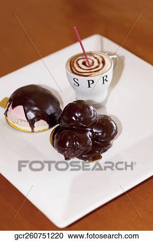 High angle view of chocolate tarts with a cup of coffee View Large Photo Image Stock Image - High angle view of chocolate tarts with a cup of coffee. Fotosearch