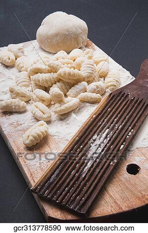 High angle view of homemade gnocchi with a mould on a cutting board View Large Photo Image Stock Image - High angle view of homemade gnocchi with a mould on a cutting board. Fotosearch