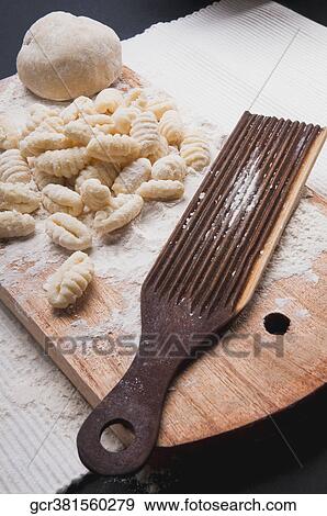 High angle view of homemade gnocchi with a mould on a cutting board View Large Photo Image Stock Photo - High angle view of homemade gnocchi with a mould on a cutting board. Fotosearch