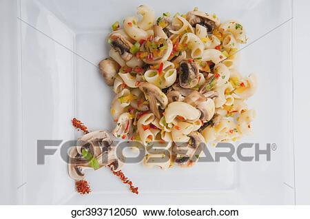 High angle view of macaroni and mushrooms on a platter View Large Photo Image Stock Image - High angle view of macaroni and mushrooms on a platter. Fotosearch