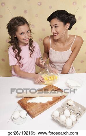 High angle view of mother and daughter baking together View Large Photo Image Stock Photography - High angle view of mother and daughter baking together. Fotosearch