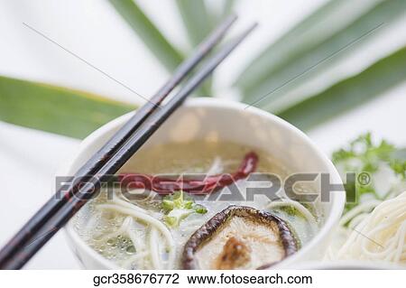 High angle view of Oriental mushroom soup with noodles View Large Photo Image Stock Image - High angle view of Oriental mushroom soup with noodles. Fotosearch