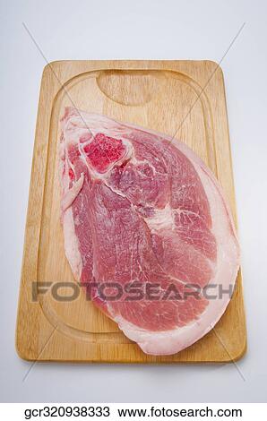 High angle view of pork on a cutting board View Large Photo Image Stock Image - High angle view of pork on a cutting board. Fotosearch