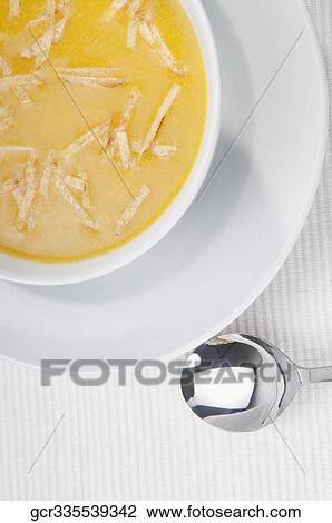 Stock Image - High angle view of pumpkin soup. Fotosearch