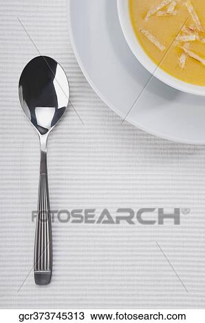 Stock Image - High angle view of pumpkin soup. Fotosearch