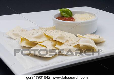 High angle view of ravioli served with tomato sauce and grated cheese View Large Photo Image Stock Image - High angle view of ravioli served with tomato sauce and grated cheese. Fotosearch
