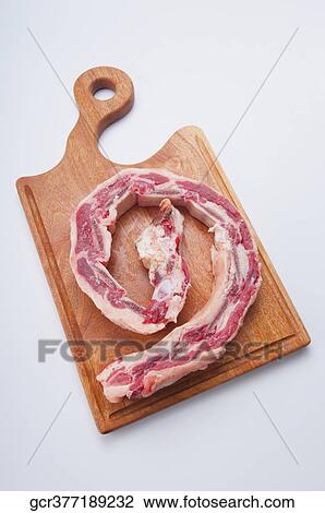 High angle view of raw spare ribs on a cutting board View Large Photo Image Stock Image - High angle view of raw spare ribs on a cutting board. Fotosearch