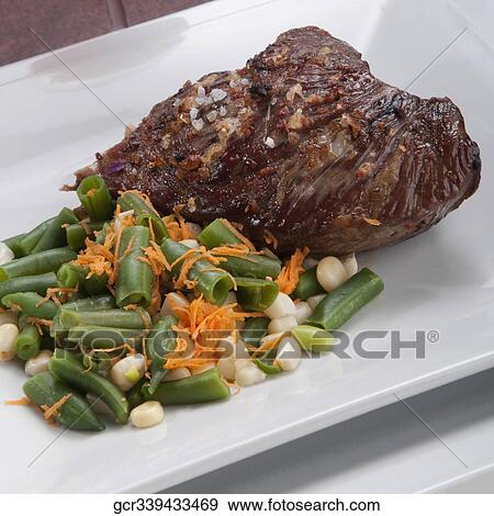 High angle view of steak served with green beans View Large Photo Image Stock Photo - High angle view of steak served with green beans. Fotosearch
