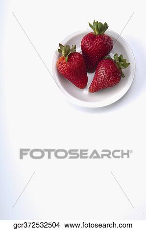 High angle view of strawberries in a plate View Large Photo Image Picture - High angle view of strawberries in a plate. Fotosearch