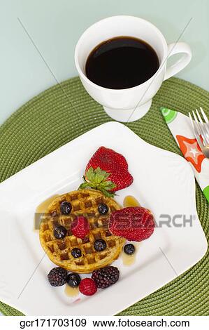Stock Photo - High angle view of strawberries with waffles and a cup of coffee. Fotosearch